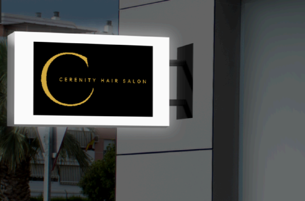 Illuminated lightbox cabinet sign for Cerenity Hair Salon glowing on a building wall