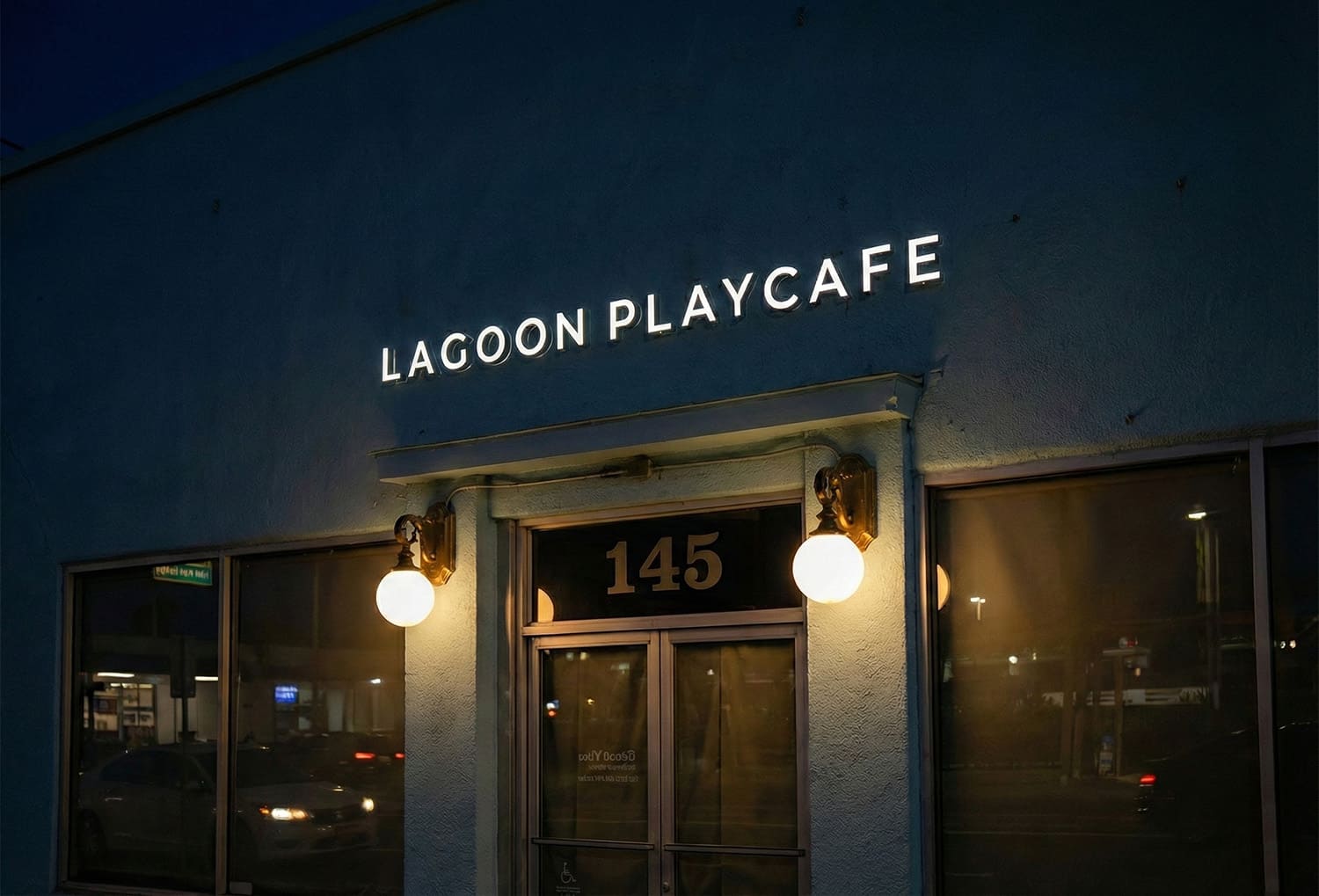 Lagoon Playcafe storefront with halo-lit white letters above the entrance